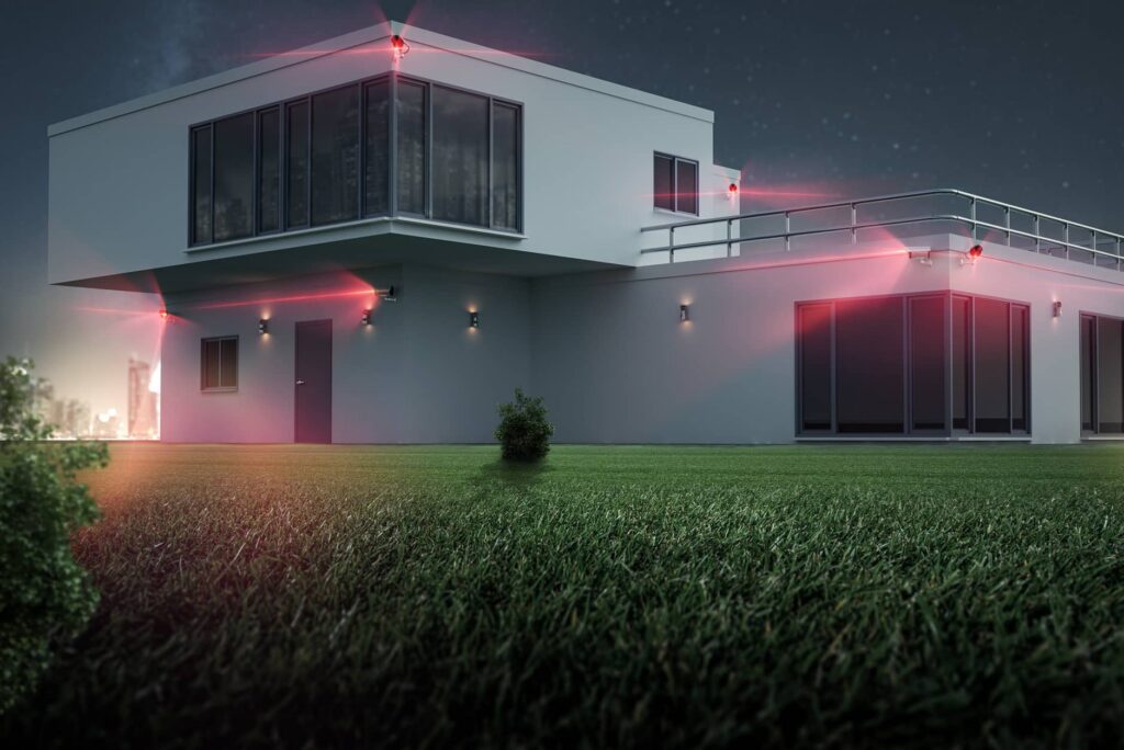 Auf diesem Bild ist ein Haus zu sehen. Es befinden sich viele Überwachungskameras an Ecken und Kanten. Sie leuchten rot.